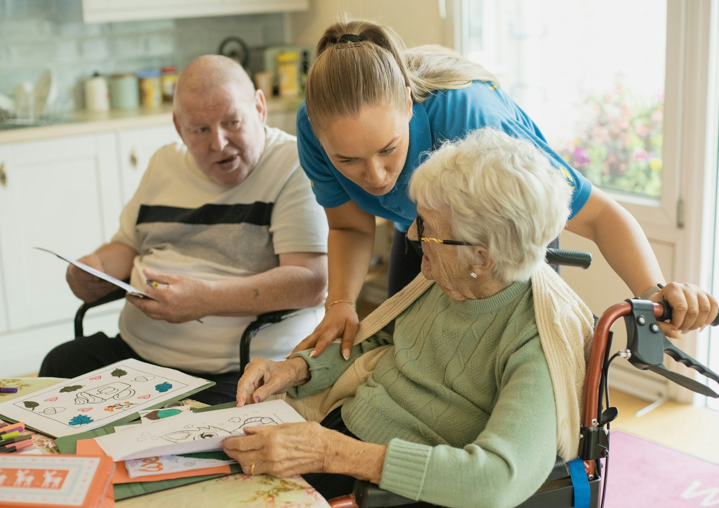 A support worker chatting with an older couple